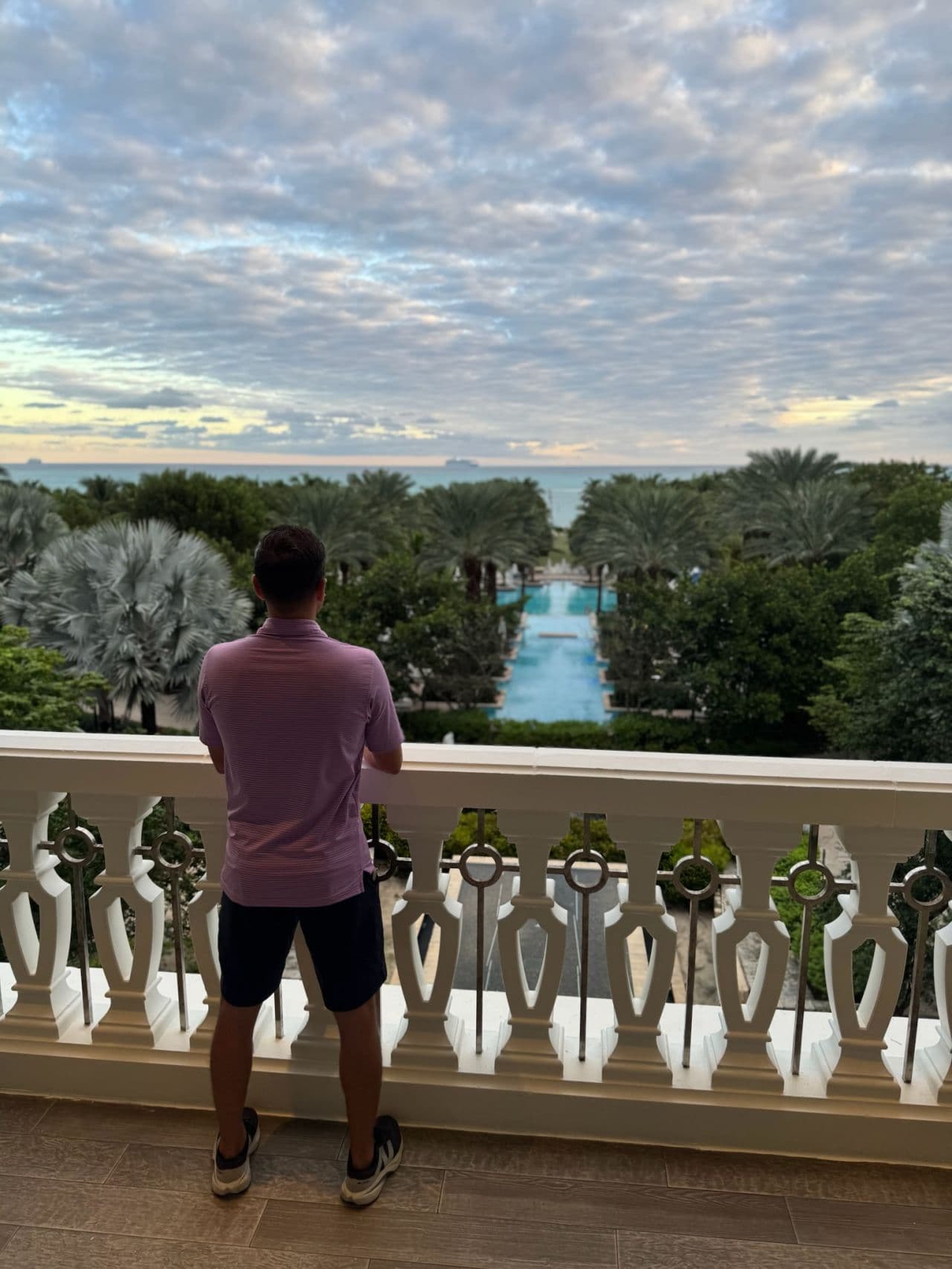 Ken Yarmosh looking out over a resort pool at sunset